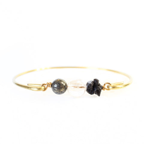 gold brass bangle with pyrite, quartz and black tourmaline beads with white background