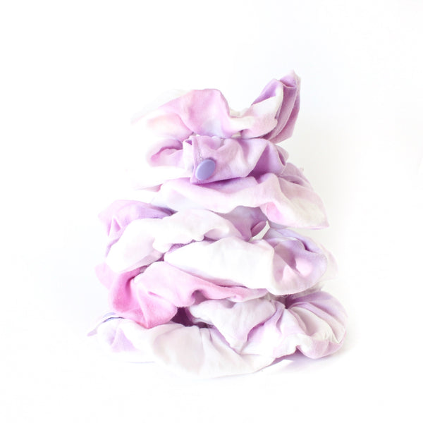 stack of purple and white tie dye scrunchie with a snap open pocket to store your goodies in. white background.