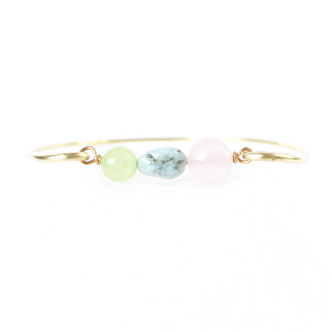 gold brass bangle with jade, larimar and rose quartz beads in the center. white background