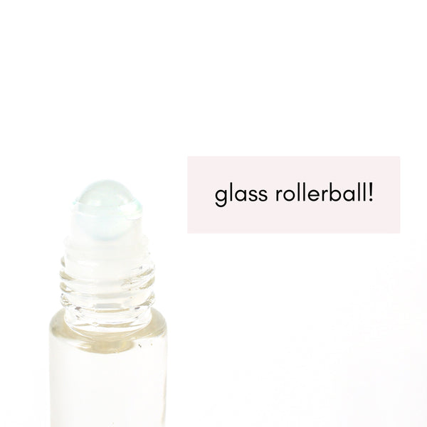 white background, glass oil roller bottle without the lid, showing that the rollerball on the bottle is glass