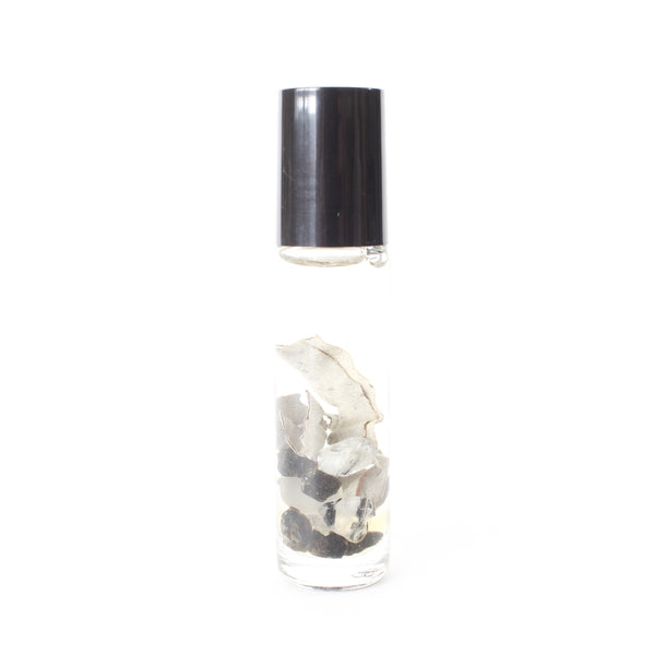 white background, clear glass oil roller bottle with a black lid. inside is dried sage, cats eye, black tourmaline and tourmalinated quartz in an oil blend. 